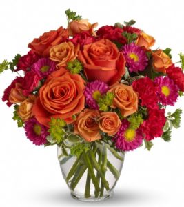Orange roses with red asters in vase