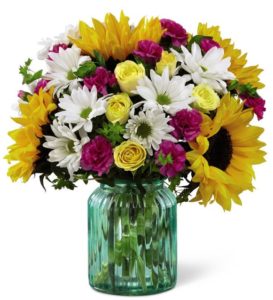 sunflowers and white daisies and other flowers in vase