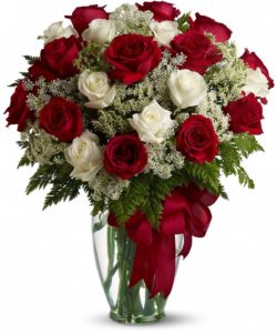 At almost two feet tall, this beautiful mix of red and white roses - accented with Queen Anne's Lace, and adorned with a bold red ribbon 