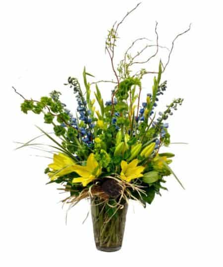 Good spring vibes resonate from this gorgeous design! Yellow Lilies, Blue Delphinium, Yellow Gladiolas and Curly Willow accentuate this wild spring look.
