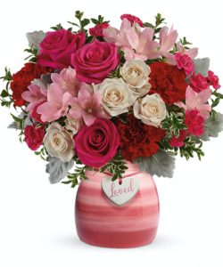 Crème spray roses, pink alstroemeria, red carnations, and hot pink miniature carnations are arranged with dusty miller and oregonia.